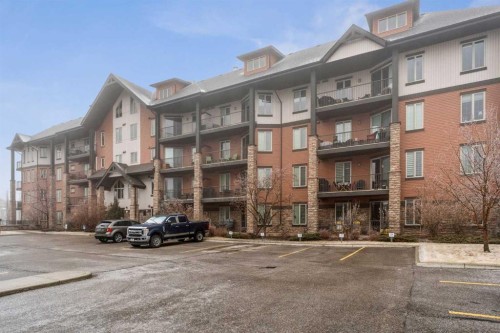 2410-15 Sunset Square, Cochrane, AB - Outdoor With Balcony With Facade