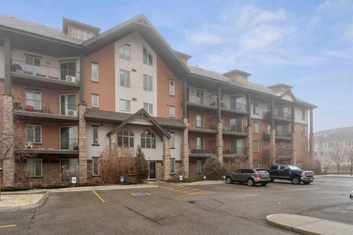 2410-15 Sunset Square, Cochrane, AB - Outdoor With Balcony With Facade