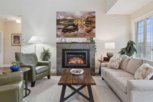 2410-15 Sunset Square, Cochrane, AB - Indoor Photo Showing Living Room With Fireplace