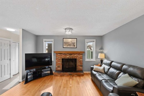 79 Macewan Meadow Rise Nw, Calgary, AB - Indoor Photo Showing Living Room With Fireplace