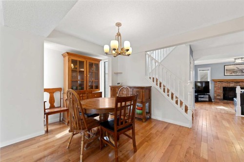 79 Macewan Meadow Rise Nw, Calgary, AB - Indoor Photo Showing Dining Room With Fireplace