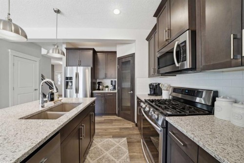 141 Willow Park, Cochrane, AB - Indoor Photo Showing Kitchen With Stainless Steel Kitchen With Double Sink With Upgraded Kitchen
