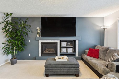 67 Copperfield Rise Se, Calgary, AB - Indoor Photo Showing Living Room With Fireplace