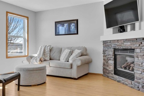 192 Somerglen Common, Calgary, AB - Indoor Photo Showing Living Room With Fireplace