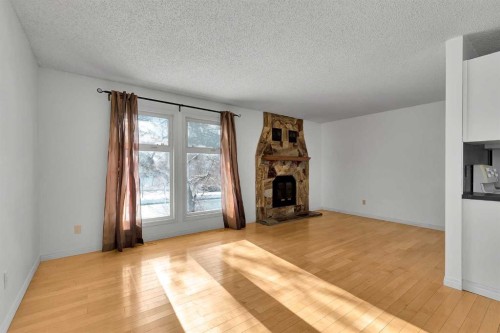 295 Edgepark Boulevard Nw, Calgary, AB - Indoor Photo Showing Living Room With Fireplace