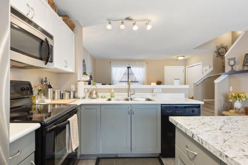 352 Elgin Gardens Se, Calgary, AB - Indoor Photo Showing Kitchen With Double Sink
