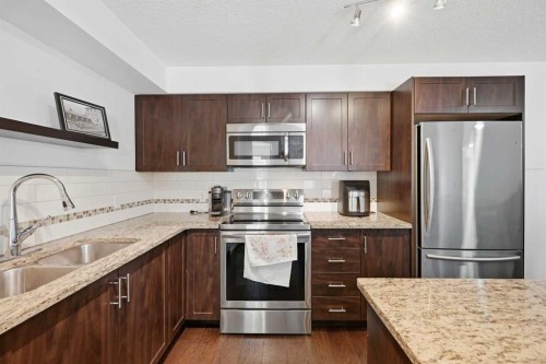 2102-279 Copperpond Common Se, Calgary, AB - Indoor Photo Showing Kitchen With Stainless Steel Kitchen With Double Sink With Upgraded Kitchen