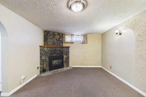 307 Wascana Road Se, Calgary, AB - Indoor Photo Showing Other Room With Fireplace