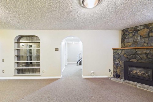 307 Wascana Road Se, Calgary, AB - Indoor Photo Showing Living Room With Fireplace