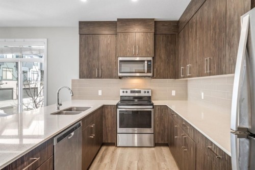 1005 Sage Meadows Gardens Nw, Calgary, AB - Indoor Photo Showing Kitchen With Stainless Steel Kitchen With Double Sink With Upgraded Kitchen