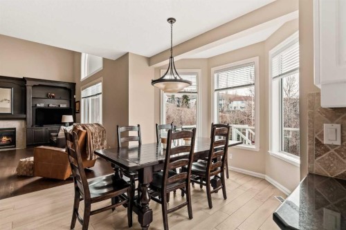 70 Patterson Close Sw, Calgary, AB - Indoor Photo Showing Dining Room With Fireplace