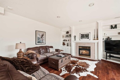 70 Patterson Close Sw, Calgary, AB - Indoor Photo Showing Living Room With Fireplace