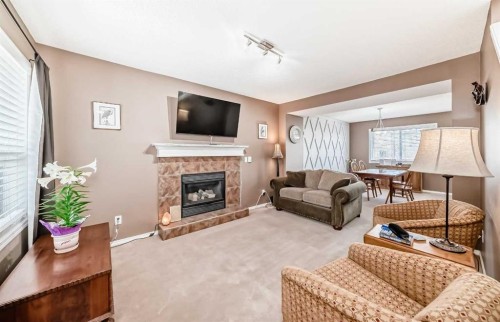 67 Cimarron Meadows Bay, Okotoks, AB - Indoor Photo Showing Living Room With Fireplace