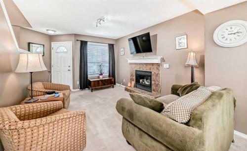 67 Cimarron Meadows Bay, Okotoks, AB - Indoor Photo Showing Living Room With Fireplace