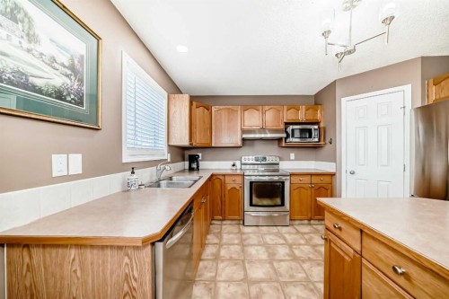 67 Cimarron Meadows Bay, Okotoks, AB - Indoor Photo Showing Kitchen With Double Sink