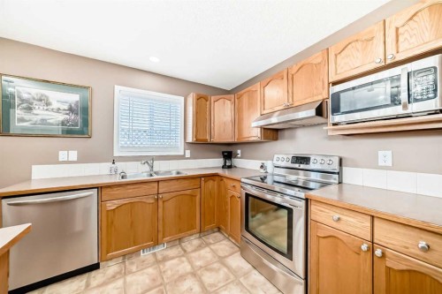 67 Cimarron Meadows Bay, Okotoks, AB - Indoor Photo Showing Kitchen With Double Sink