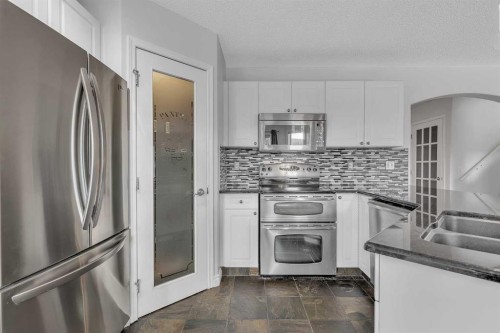 92 Bow Ridge Crescent, Cochrane, AB - Indoor Photo Showing Kitchen With Stainless Steel Kitchen With Double Sink With Upgraded Kitchen