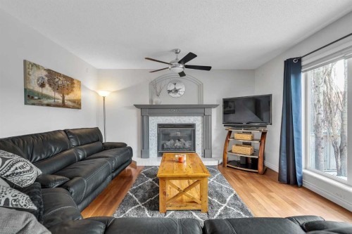 92 Bow Ridge Crescent, Cochrane, AB - Indoor Photo Showing Living Room With Fireplace