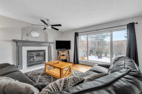 92 Bow Ridge Crescent, Cochrane, AB - Indoor Photo Showing Living Room With Fireplace