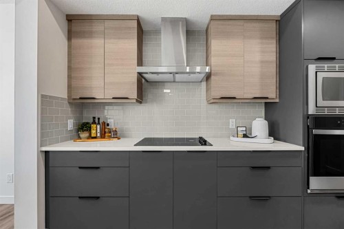 121 Quartz Crescent, Cochrane, AB - Indoor Photo Showing Kitchen With Upgraded Kitchen