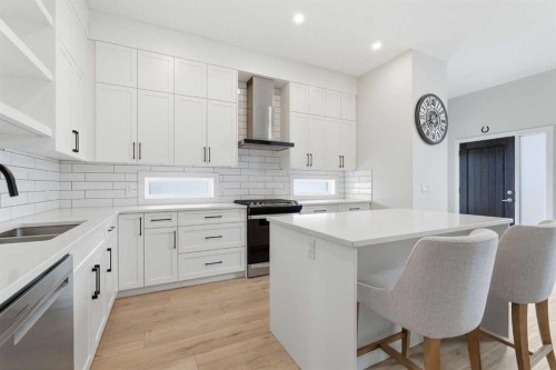 56 Iris Crescent, Okotoks, AB - Indoor Photo Showing Kitchen With Double Sink With Upgraded Kitchen