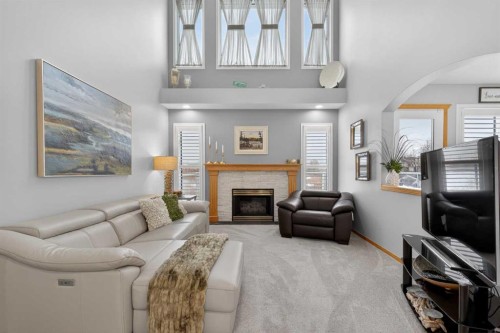 129 Bridlecreek Green Sw, Calgary, AB - Indoor Photo Showing Living Room With Fireplace