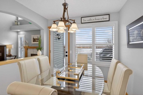 129 Bridlecreek Green Sw, Calgary, AB - Indoor Photo Showing Dining Room With Fireplace