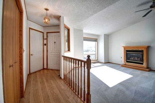 273 Woodside Road Nw, Airdrie, AB - Indoor Photo Showing Other Room With Fireplace