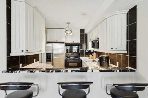 37 Ranch Glen Drive Nw, Calgary, AB - Indoor Photo Showing Kitchen With Double Sink