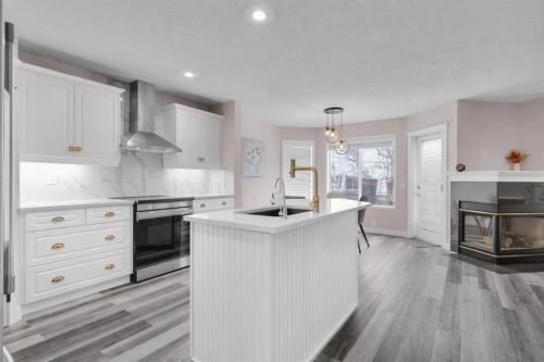 6 Douglas Woods Bay Se, Calgary, AB - Indoor Photo Showing Kitchen With Fireplace