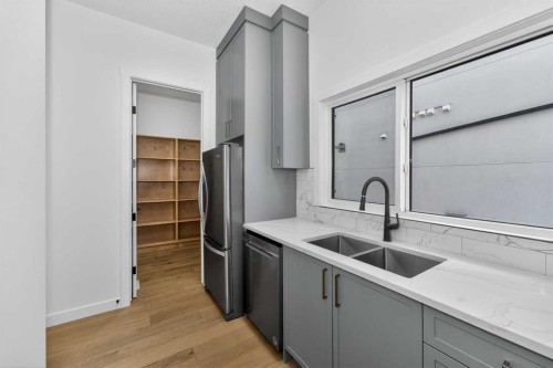 1049 Waterstone Green, Chestermere, AB - Indoor Photo Showing Kitchen With Double Sink