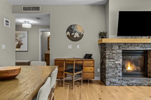 200-707 Spring Creek Drive, Canmore, AB - Indoor Photo Showing Living Room With Fireplace