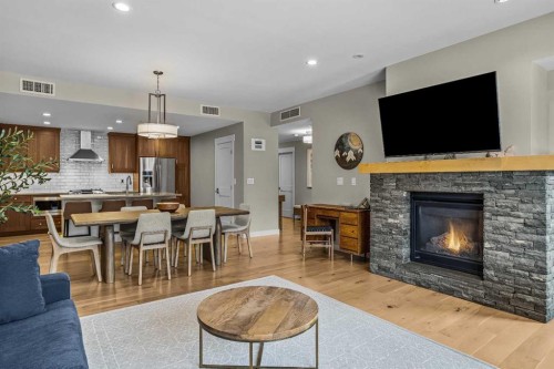 200-707 Spring Creek Drive, Canmore, AB - Indoor Photo Showing Living Room With Fireplace