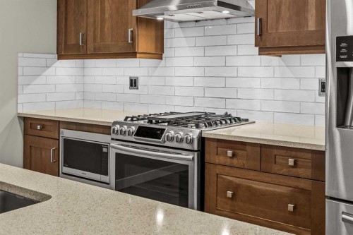 200-707 Spring Creek Drive, Canmore, AB - Indoor Photo Showing Kitchen With Upgraded Kitchen