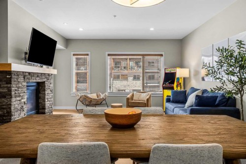 200-707 Spring Creek Drive, Canmore, AB - Indoor Photo Showing Living Room With Fireplace