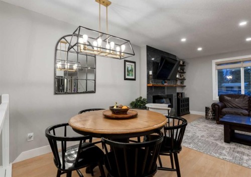 4627 Verona Drive Nw, Calgary, AB - Indoor Photo Showing Dining Room With Fireplace