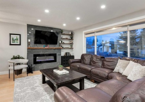 4627 Verona Drive Nw, Calgary, AB - Indoor Photo Showing Living Room With Fireplace