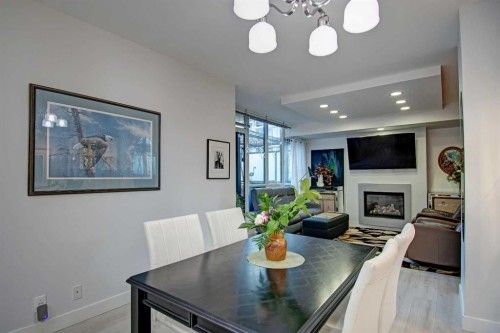 231-222 Riverfront Avenue Sw, Calgary, AB - Indoor Photo Showing Dining Room With Fireplace