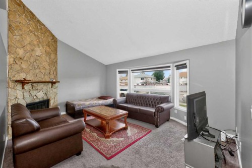 6910 26 Avenue Ne, Calgary, AB - Indoor Photo Showing Living Room With Fireplace
