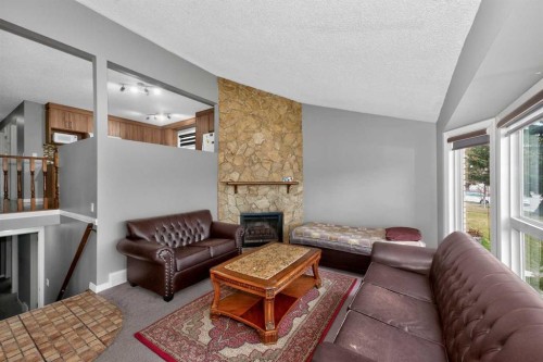 6910 26 Avenue Ne, Calgary, AB - Indoor Photo Showing Living Room With Fireplace