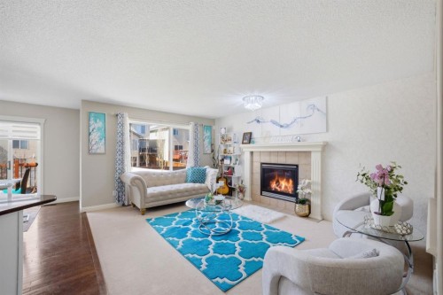 87 Kincora Drive Nw, Calgary, AB - Indoor Photo Showing Living Room With Fireplace