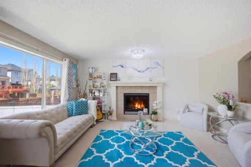 87 Kincora Drive Nw, Calgary, AB - Indoor Photo Showing Living Room With Fireplace