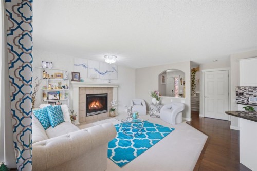 87 Kincora Drive Nw, Calgary, AB - Indoor Photo Showing Living Room With Fireplace