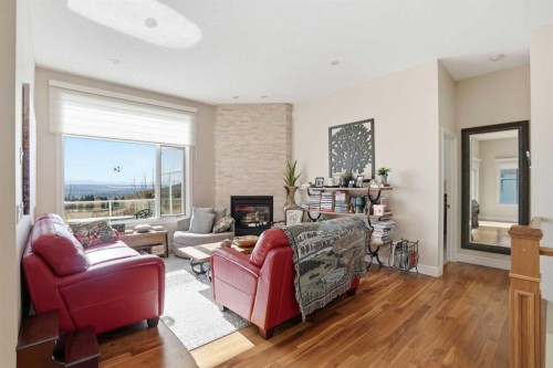 40 Eagleview Way, Cochrane, AB - Indoor Photo Showing Living Room With Fireplace