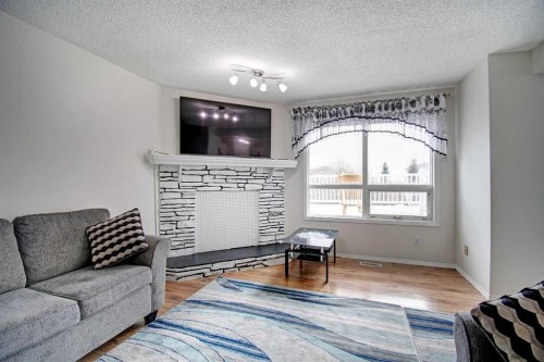10316 Hidden Valley Drive Nw, Calgary, AB - Indoor Photo Showing Living Room With Fireplace