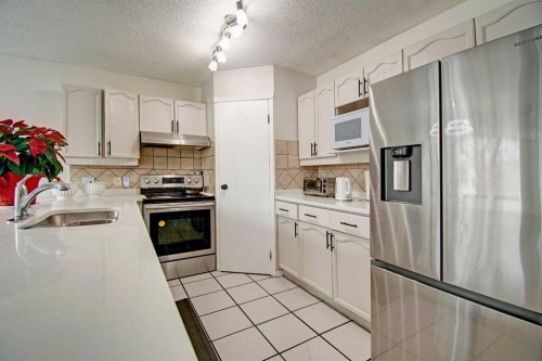 10316 Hidden Valley Drive Nw, Calgary, AB - Indoor Photo Showing Kitchen With Stainless Steel Kitchen With Double Sink