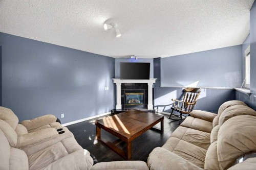 1503 Thorburn Drive Se, Airdrie, AB - Indoor Photo Showing Living Room With Fireplace