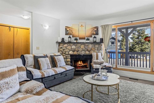 118 Glacier Drive, Banff, AB - Indoor Photo Showing Living Room With Fireplace
