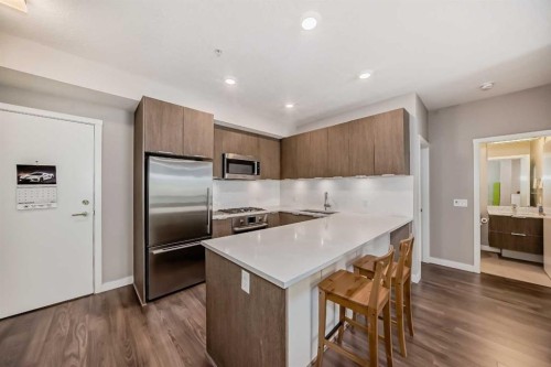 109-823 5 Avenue Nw, Calgary, AB - Indoor Photo Showing Kitchen With Stainless Steel Kitchen With Upgraded Kitchen