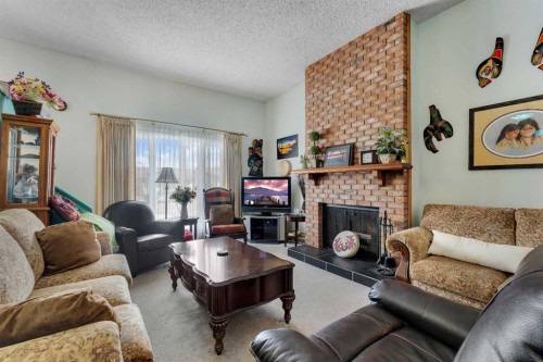 1003 Berkley Drive Nw, Calgary, AB - Indoor Photo Showing Living Room With Fireplace